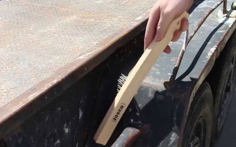 Wire brushing used during rust treatment preparation